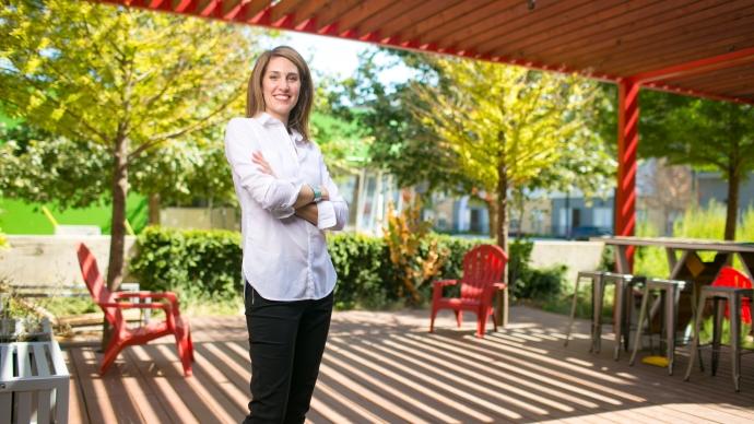 Elaine Kearney ’00 stands outside in an architectural green space