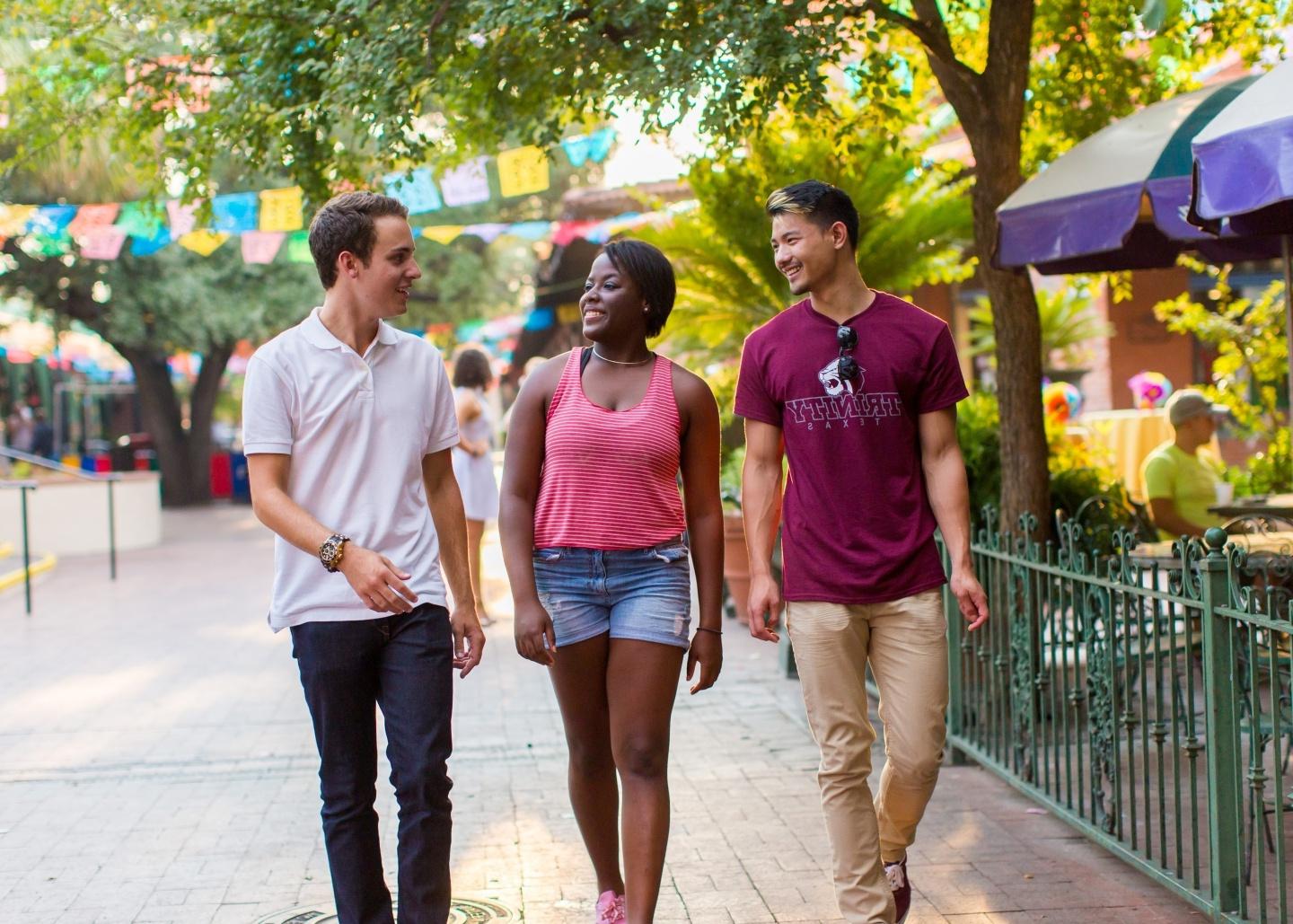 Three diverse students walking in downtown San Antonio