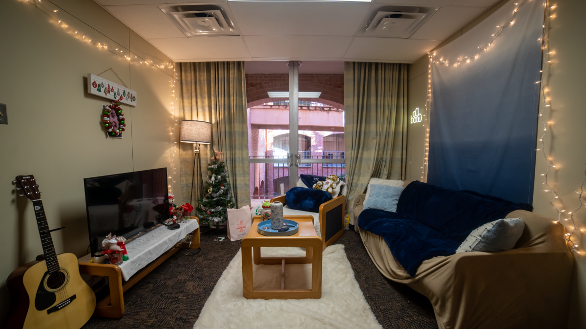 Lightner Hall dorm room living area decorated with guitar in the room and a christmas tree